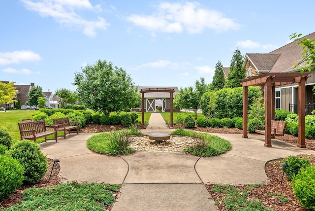 view of property's community featuring an outdoor structure and a pergola