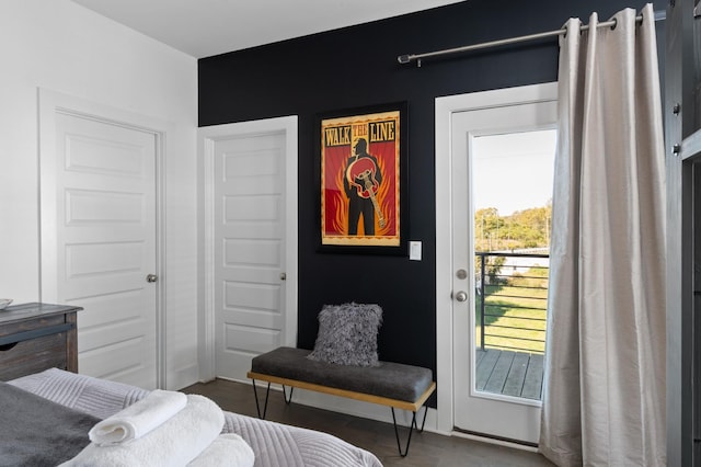 bedroom featuring access to outside and wood finished floors