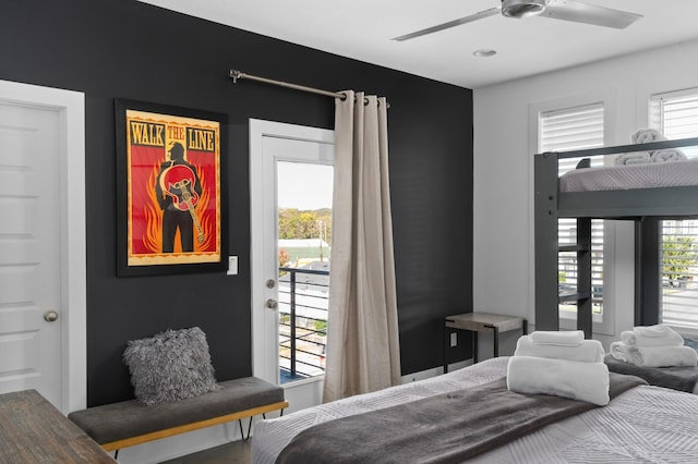 bedroom featuring multiple windows, a ceiling fan, and access to outside