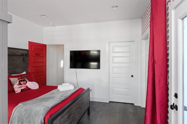 bedroom with dark wood finished floors, recessed lighting, and baseboards