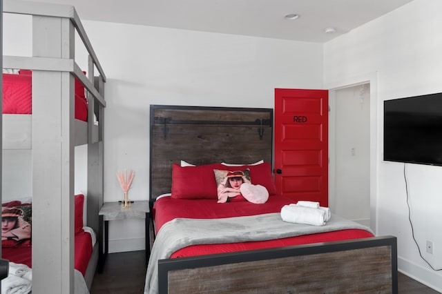 bedroom with wood finished floors and baseboards