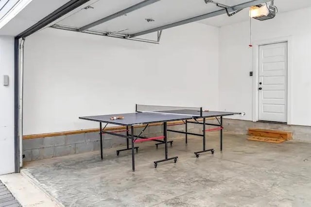 game room featuring a garage and concrete floors