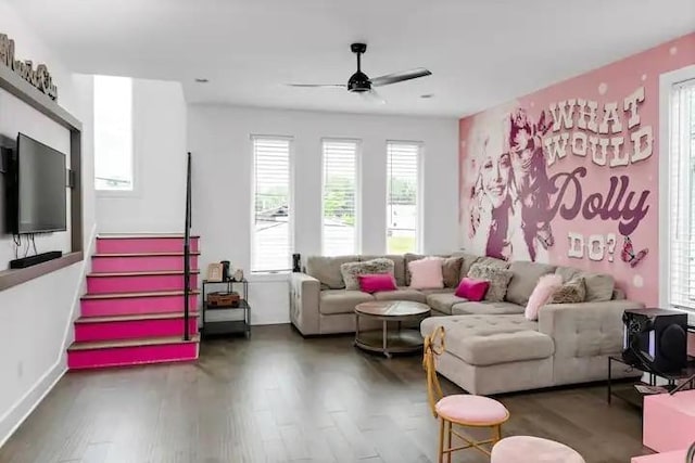 living area featuring stairs, a ceiling fan, and wood finished floors