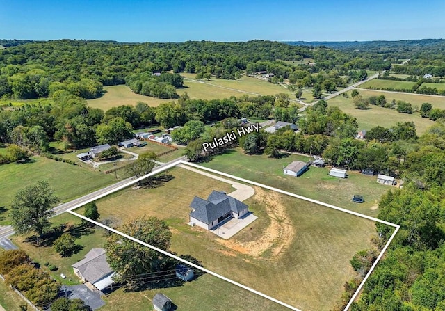 aerial view featuring a forest view and a rural view