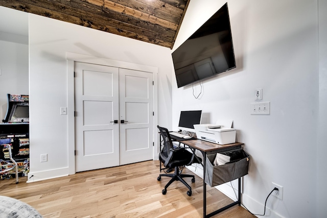 office area with light wood-type flooring, lofted ceiling, and baseboards