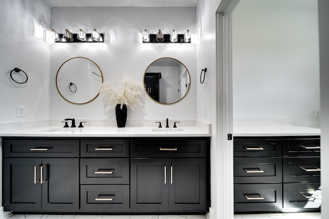 full bathroom featuring double vanity and a sink