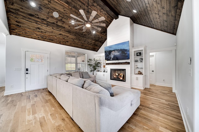 living room with light wood-type flooring, a large fireplace, high vaulted ceiling, and wooden ceiling