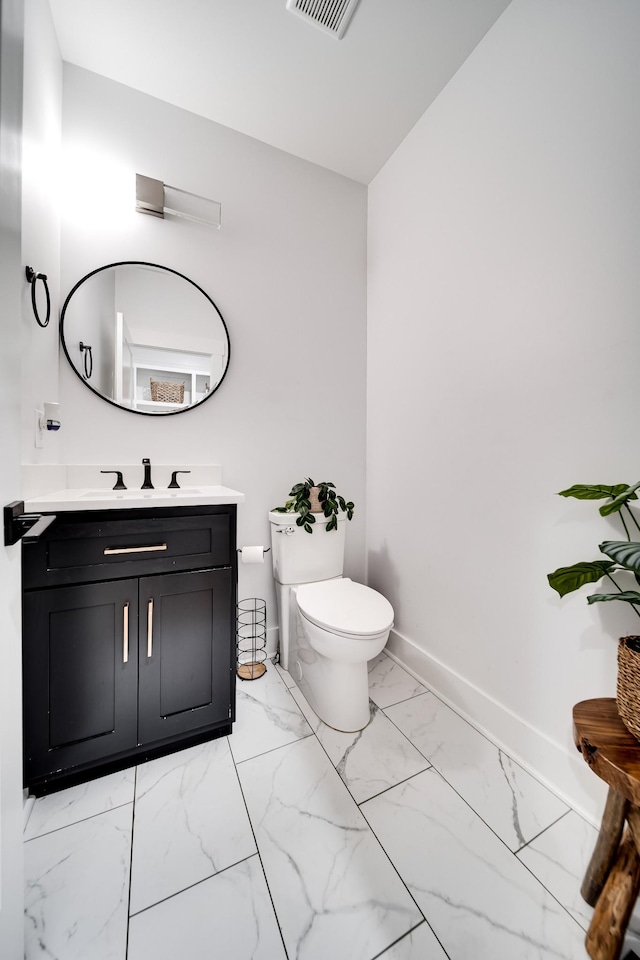 bathroom with visible vents, baseboards, toilet, marble finish floor, and vanity