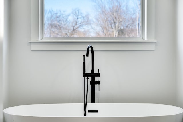 full bath featuring a sink and a soaking tub