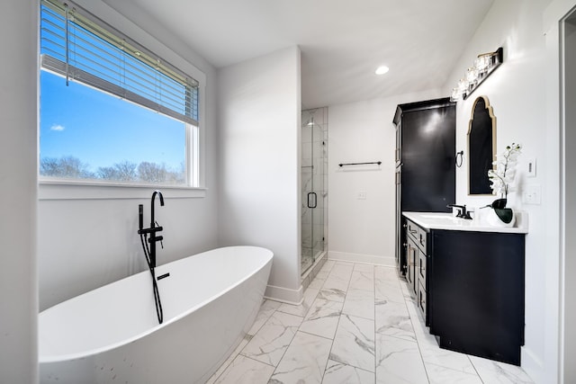 bathroom with vanity, baseboards, a soaking tub, a stall shower, and marble finish floor