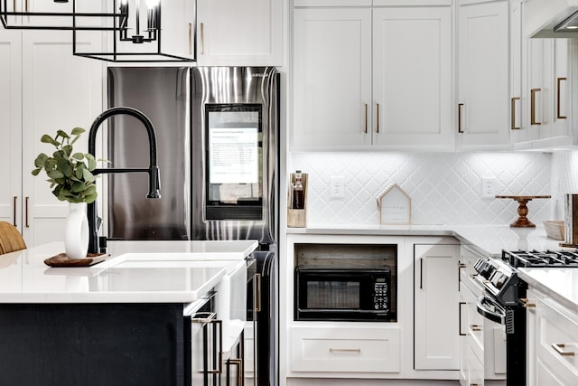 kitchen with tasteful backsplash, black appliances, light countertops, white cabinetry, and wall chimney exhaust hood