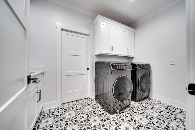 laundry area with crown molding, baseboards, washer and clothes dryer, tile patterned floors, and cabinet space