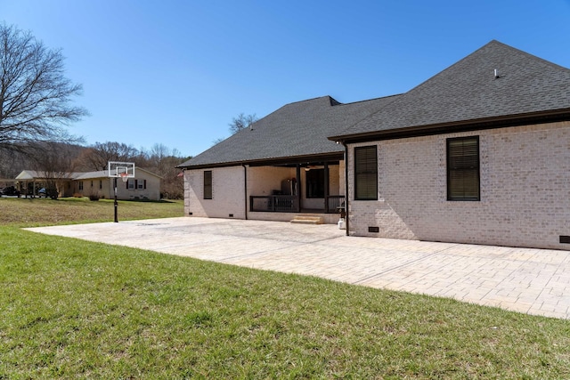 back of house with a yard, brick siding, and crawl space