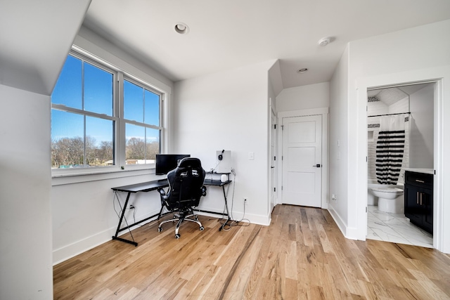 office with baseboards and light wood-type flooring