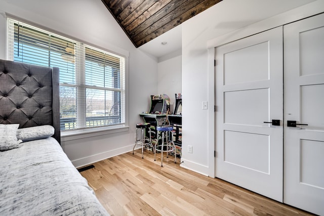 bedroom with vaulted ceiling, wood ceiling, baseboards, and light wood-type flooring