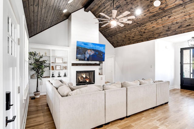 living room with light wood finished floors, wooden ceiling, and high vaulted ceiling