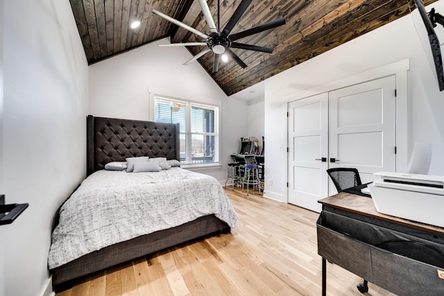 bedroom featuring beamed ceiling, wooden ceiling, baseboards, and wood finished floors