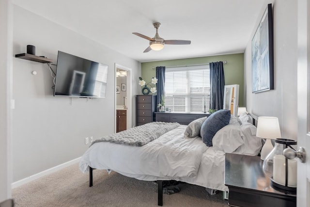 carpeted bedroom with ceiling fan, connected bathroom, and baseboards