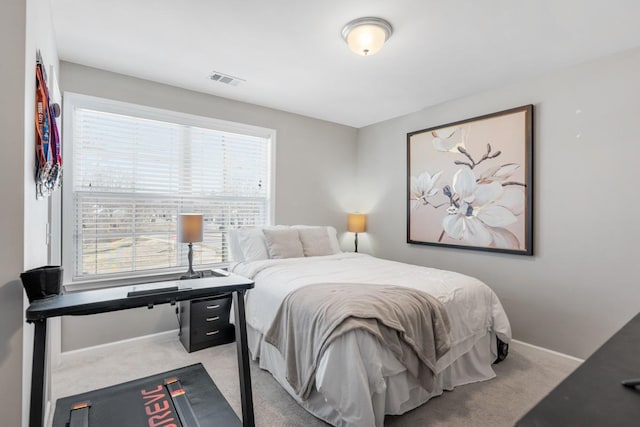 carpeted bedroom with visible vents and baseboards