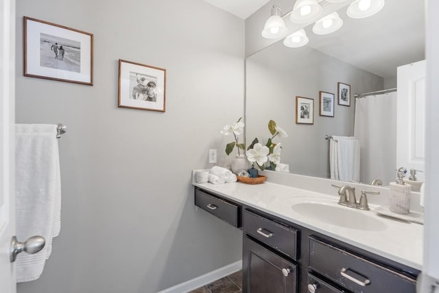 full bathroom with tile patterned floors, vanity, and baseboards