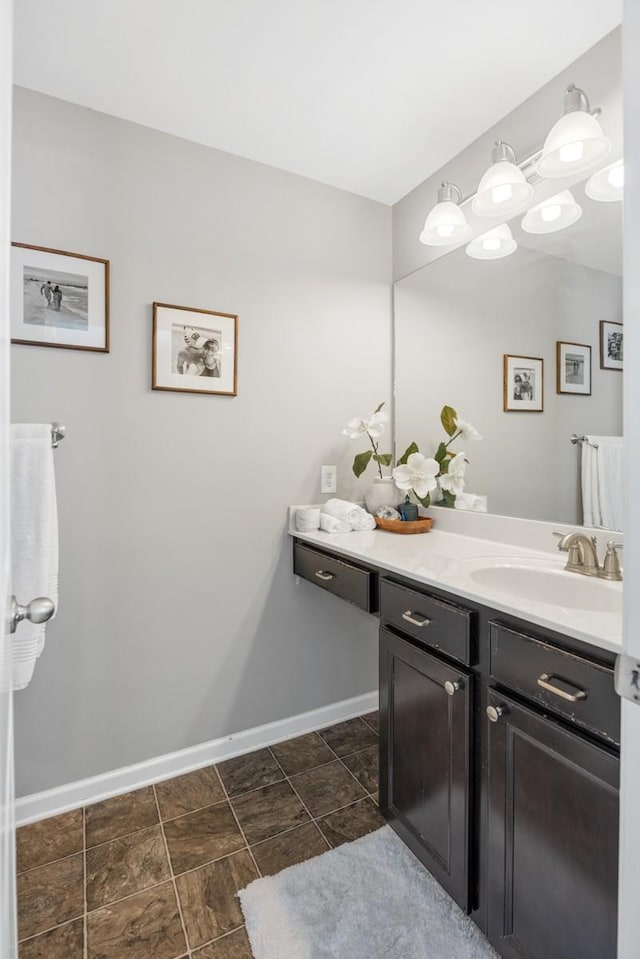 bathroom featuring baseboards and vanity