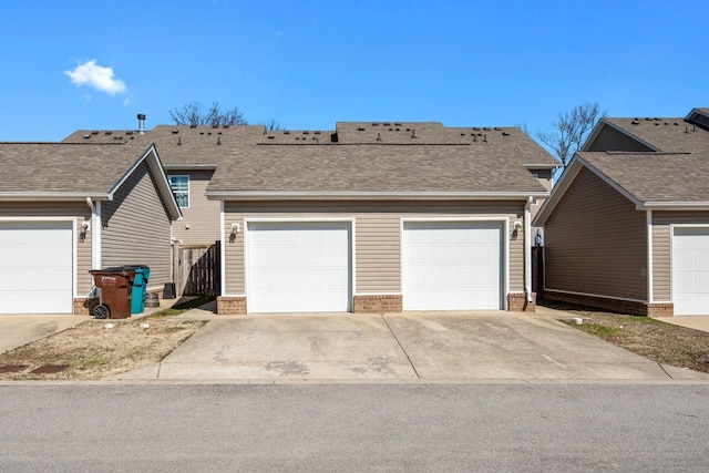 view of front of home with brick siding, a shingled roof, and a garage