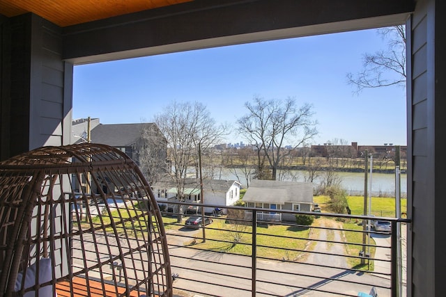 balcony with a residential view and a water view