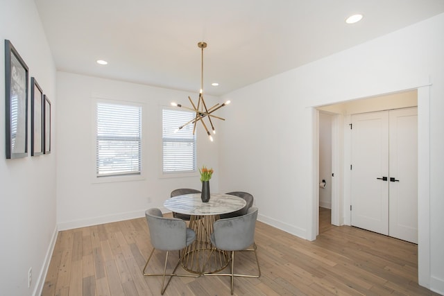 dining area with recessed lighting, a notable chandelier, baseboards, and light wood-style floors