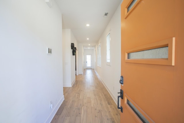 hall with visible vents, recessed lighting, baseboards, and light wood-style floors