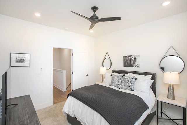 bedroom with a ceiling fan, recessed lighting, baseboards, and light carpet