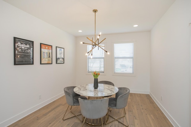 dining area featuring recessed lighting, baseboards, a notable chandelier, and light wood-style flooring