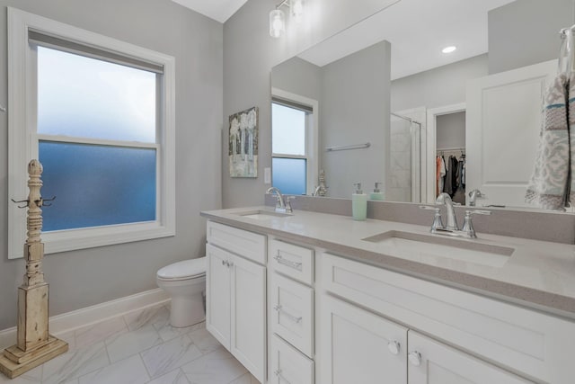 full bath with a shower stall, toilet, marble finish floor, and a sink