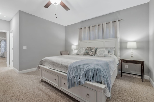 carpeted bedroom with a ceiling fan and baseboards