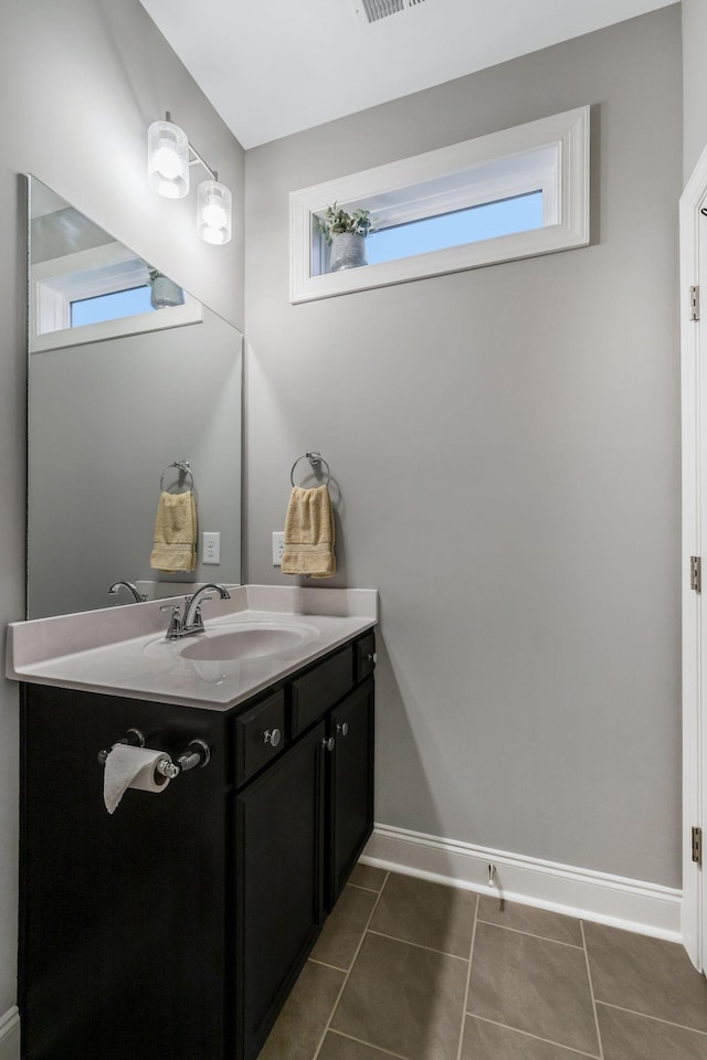 bathroom with tile patterned floors, visible vents, vanity, and baseboards