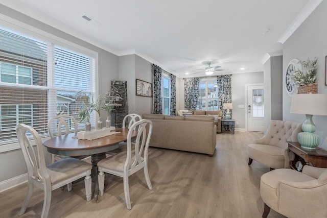 dining area featuring a wealth of natural light, visible vents, and light wood-style flooring