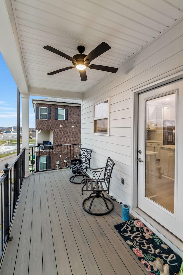 wooden deck featuring a ceiling fan