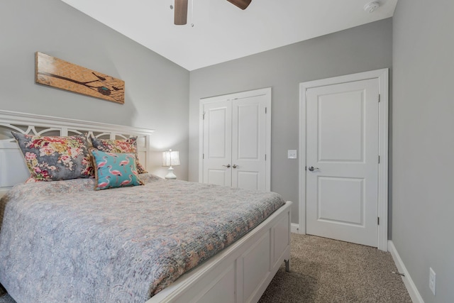 bedroom featuring a ceiling fan, light colored carpet, a closet, and baseboards