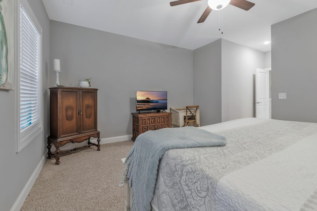 bedroom with baseboards, light carpet, and ceiling fan