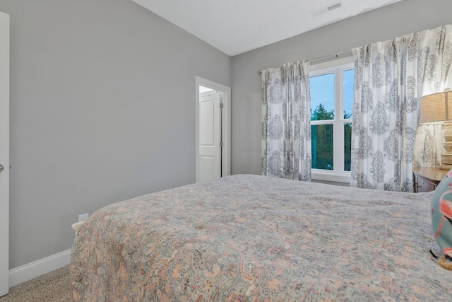 carpeted bedroom featuring visible vents and baseboards