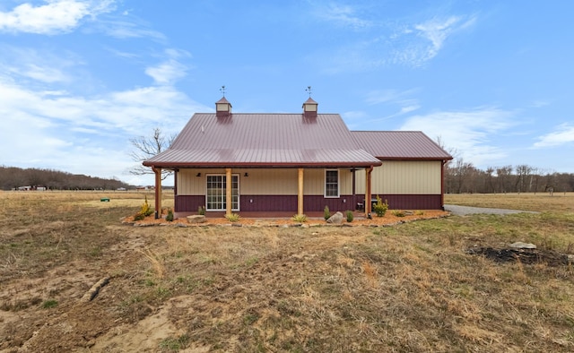 rear view of house with a porch and metal roof