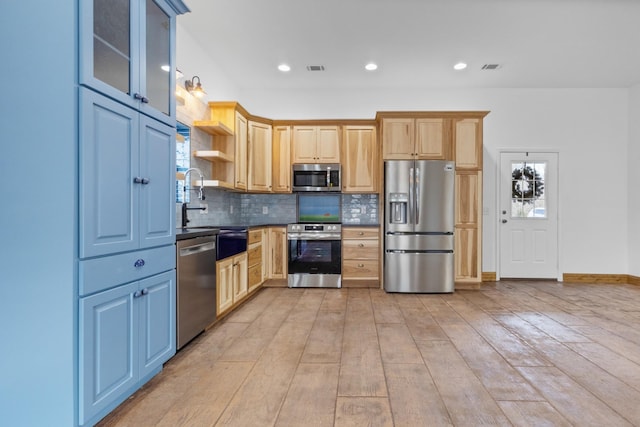 kitchen with decorative backsplash, open shelves, light wood-type flooring, and appliances with stainless steel finishes