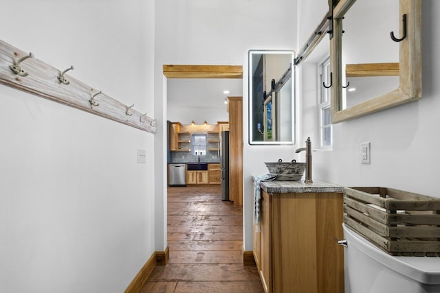 hall with baseboards and dark wood-style floors