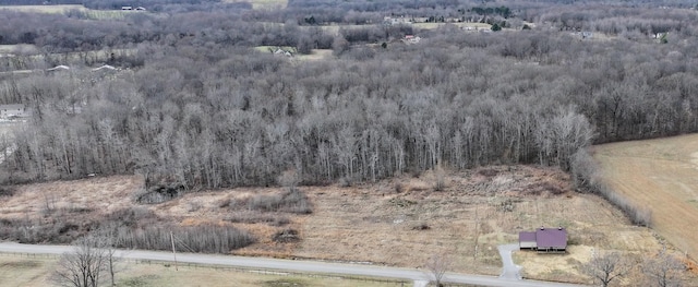 drone / aerial view featuring a rural view and a wooded view