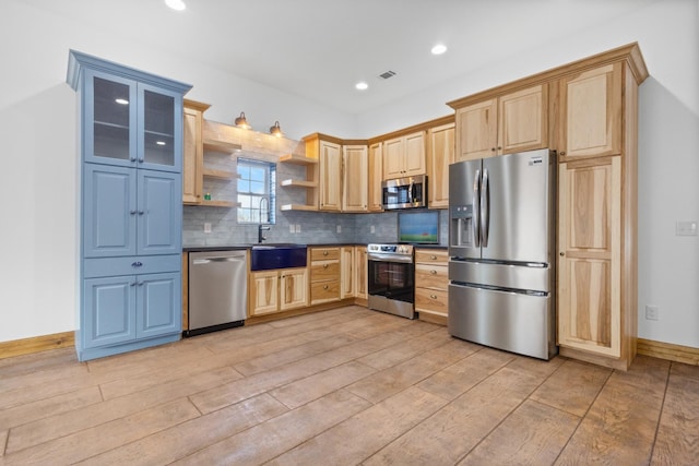 kitchen featuring open shelves, a sink, stainless steel appliances, dark countertops, and tasteful backsplash