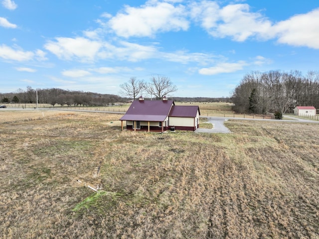 view of yard featuring an outbuilding and a rural view