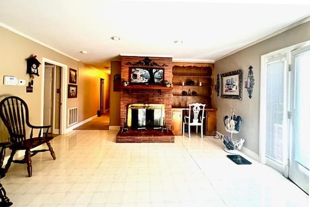 living area featuring visible vents, baseboards, a brick fireplace, and crown molding