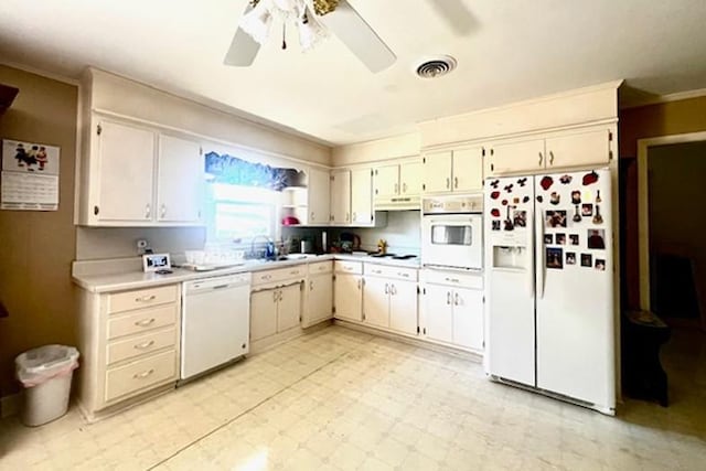 kitchen featuring visible vents, light floors, light countertops, white appliances, and a ceiling fan