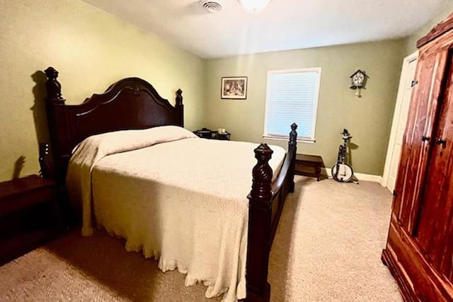 carpeted bedroom featuring visible vents and baseboards