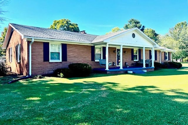 view of front of house with a front yard and a porch