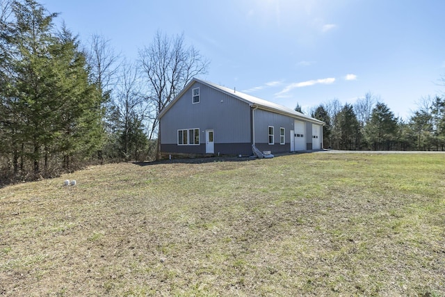 view of home's exterior featuring a garage and a lawn